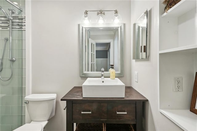 bathroom with vanity, a shower with door, and toilet