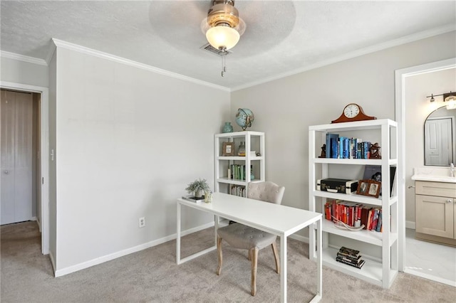 office space featuring ceiling fan, crown molding, and light carpet