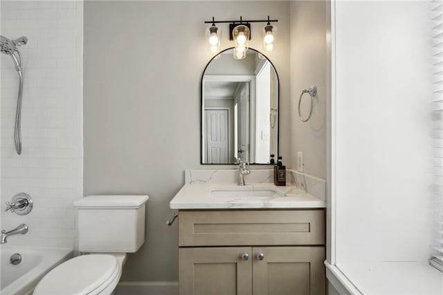 full bathroom with vanity, tiled shower / bath combo, and toilet