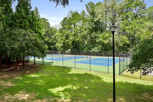 view of tennis court with a lawn