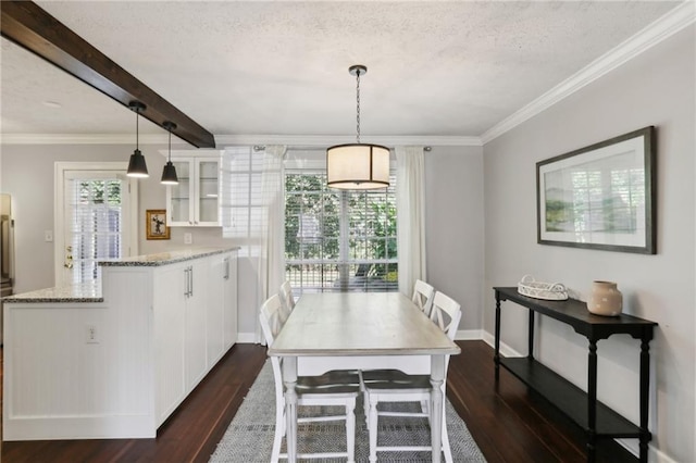 dining space with ornamental molding, a textured ceiling, and dark hardwood / wood-style flooring