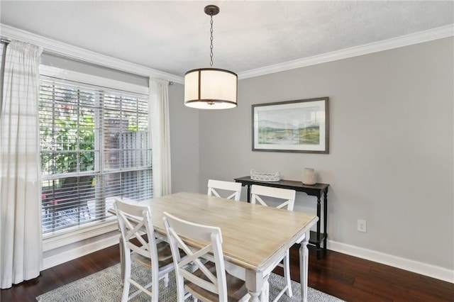 dining area featuring ornamental molding and dark hardwood / wood-style flooring