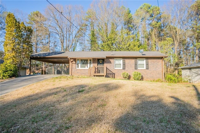 ranch-style house featuring aphalt driveway, an attached carport, a front lawn, and brick siding