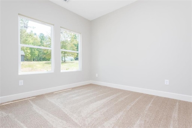 carpeted spare room with baseboards