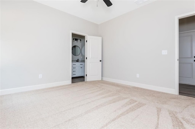 spare room featuring carpet flooring, a ceiling fan, and baseboards