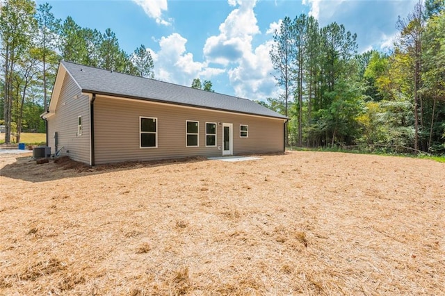 rear view of house featuring central air condition unit