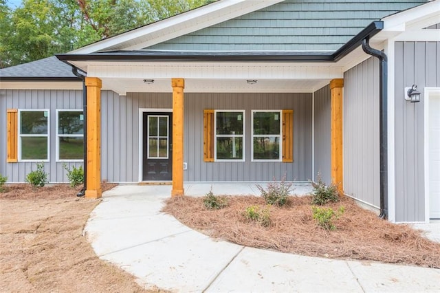 entrance to property featuring covered porch and board and batten siding