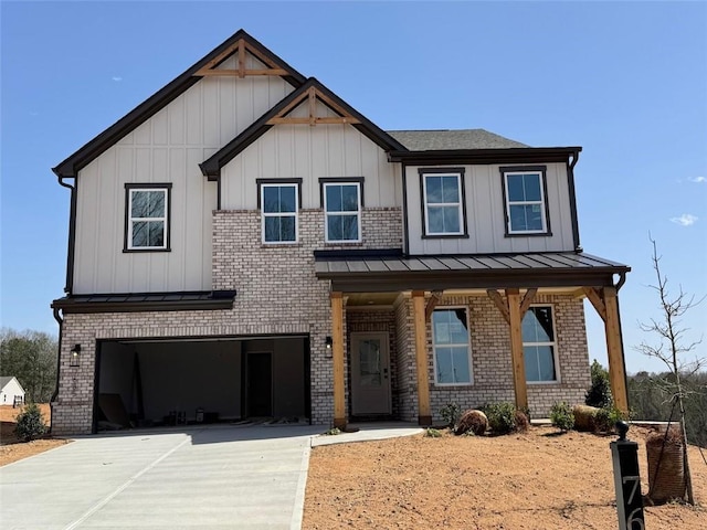 view of front of house featuring driveway, a standing seam roof, brick siding, a garage, and board and batten siding