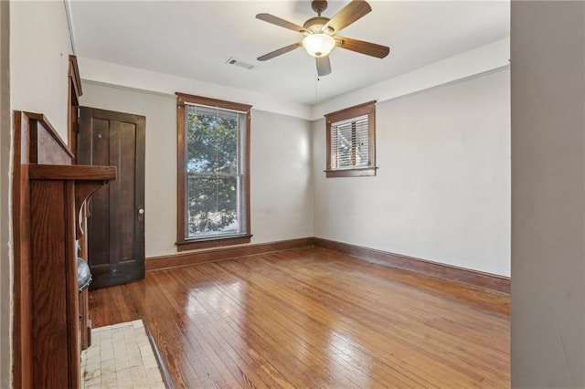 empty room featuring wood-type flooring and ceiling fan