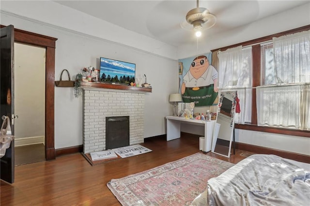 bedroom featuring a fireplace and dark hardwood / wood-style floors