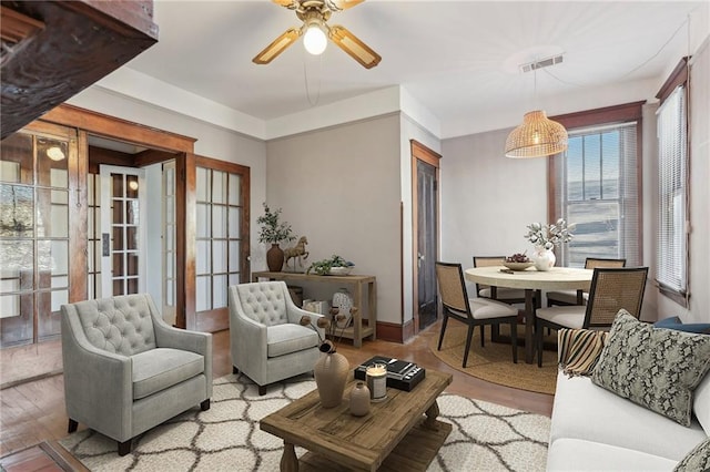 living room with ceiling fan and light hardwood / wood-style floors