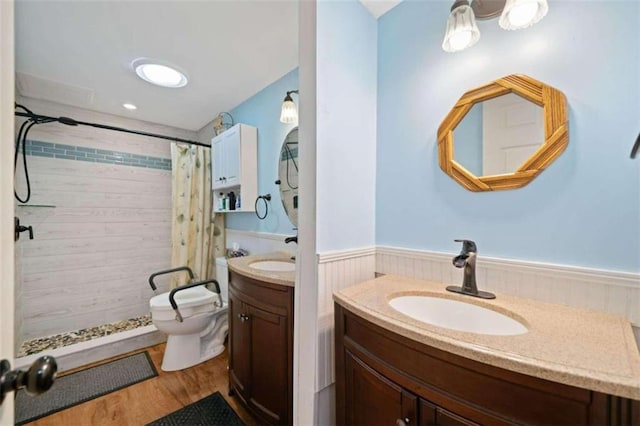 bathroom with vanity, toilet, wood-type flooring, and walk in shower