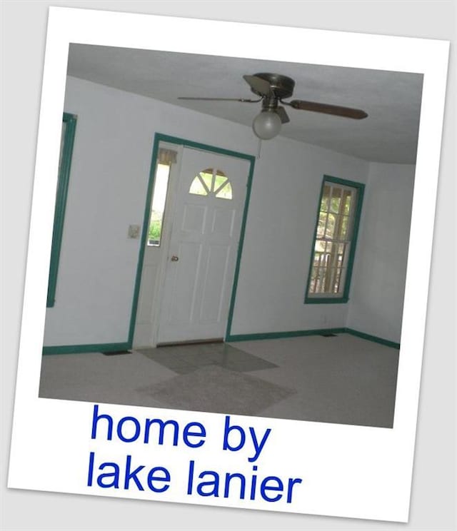 foyer entrance featuring ceiling fan and baseboards