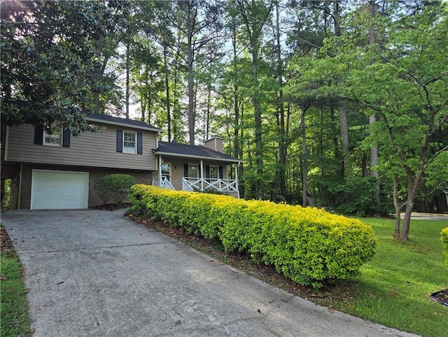 4015 Woodland Dr NW, Kennesaw, GA 30152 - tri-level home with brick siding, covered porch, driveway, a garage, and a chimney