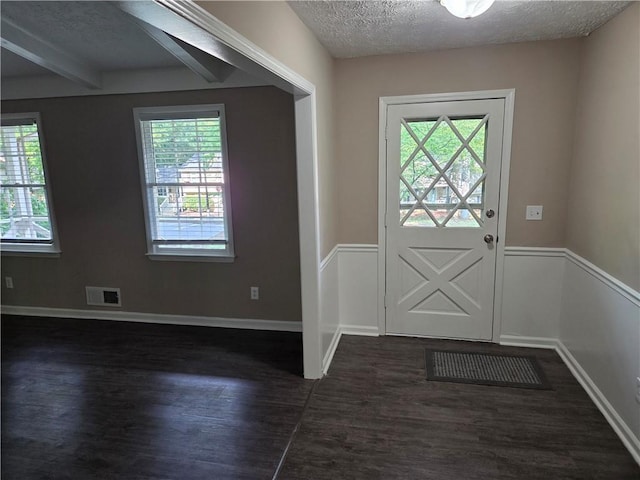 4015 Woodland Dr NW, Kennesaw, GA 30152 - doorway with dark wood-style floors, a textured ceiling, wainscoting, and beamed ceiling