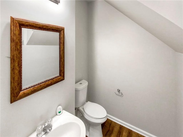 bathroom with toilet and hardwood / wood-style floors