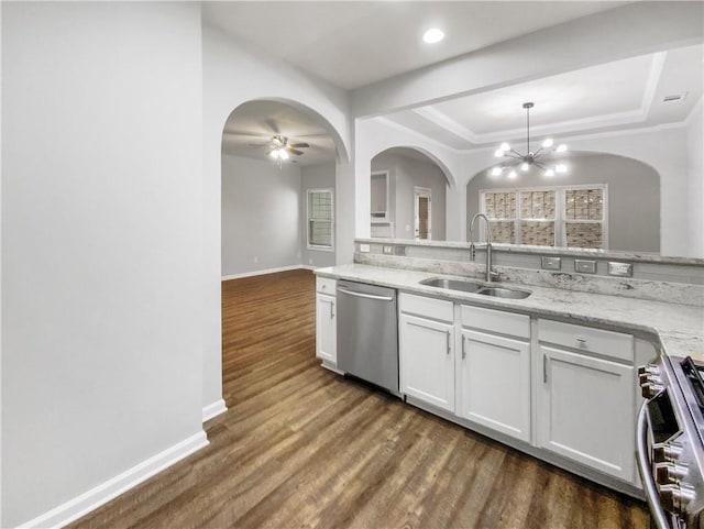 kitchen featuring stainless steel appliances, sink, white cabinetry, ceiling fan with notable chandelier, and hanging light fixtures