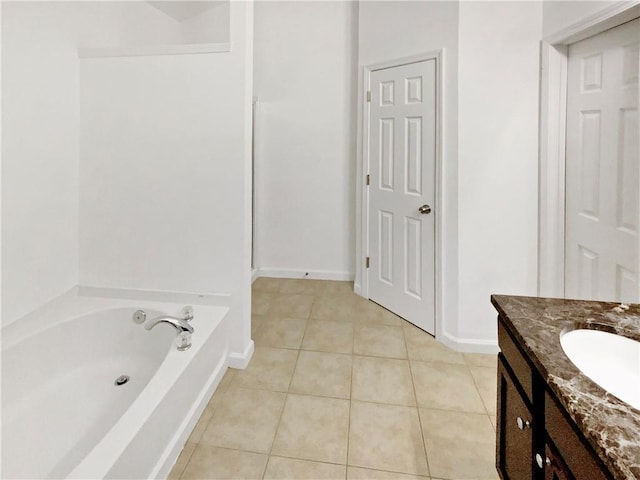 bathroom with a bathtub, tile patterned floors, and vanity