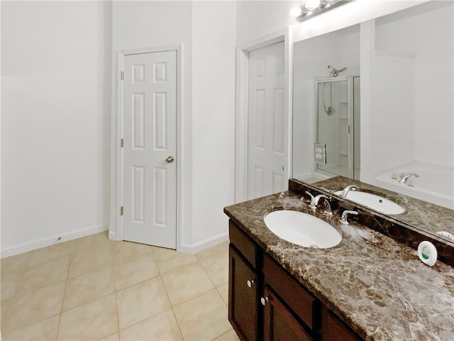 bathroom featuring shower with separate bathtub, vanity, and tile patterned floors