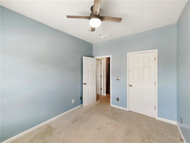 unfurnished bedroom with light colored carpet and ceiling fan