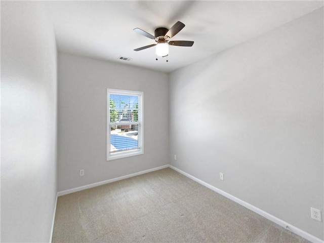 carpeted spare room featuring ceiling fan