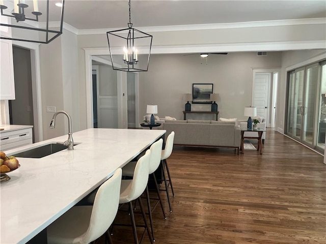 dining room featuring hardwood / wood-style flooring, a chandelier, and ornamental molding