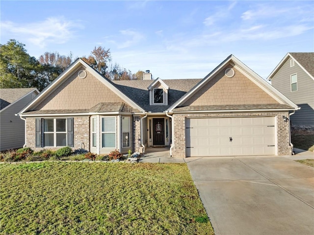 view of front of home with a garage and a front lawn