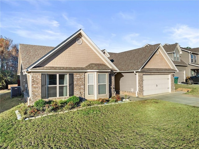 view of front facade with a front yard, central AC, and a garage