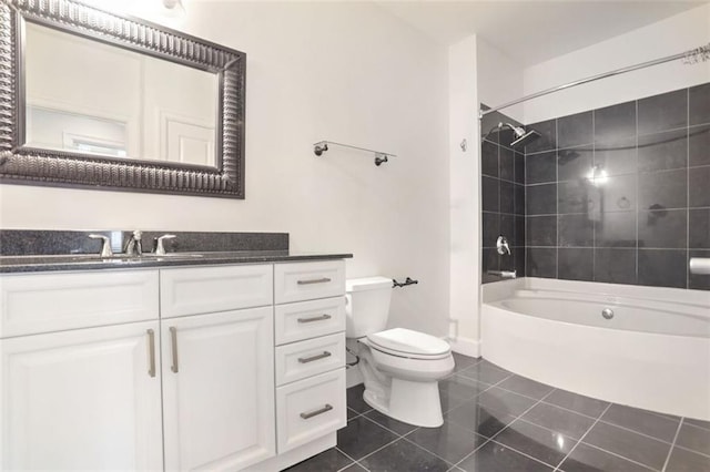 full bathroom with tiled shower / bath combo, vanity, tile patterned flooring, and toilet