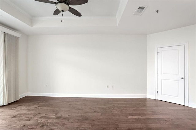 unfurnished room featuring crown molding, dark hardwood / wood-style floors, ceiling fan, and a tray ceiling