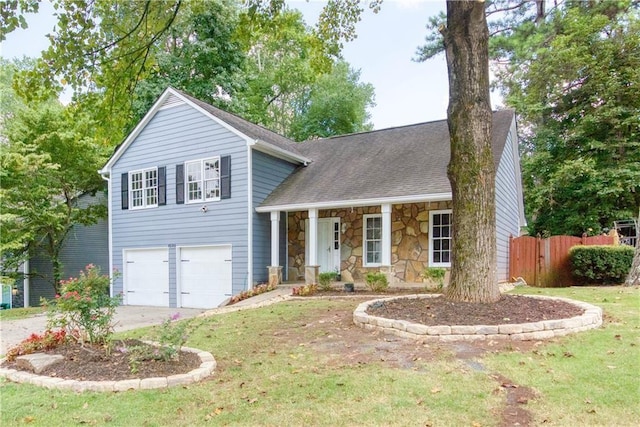 split level home with a porch, a garage, and a front yard