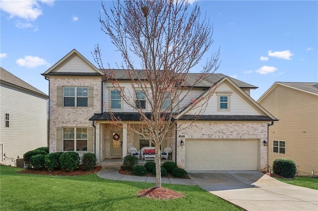 view of front of house featuring brick siding, a front lawn, a porch, a garage, and driveway