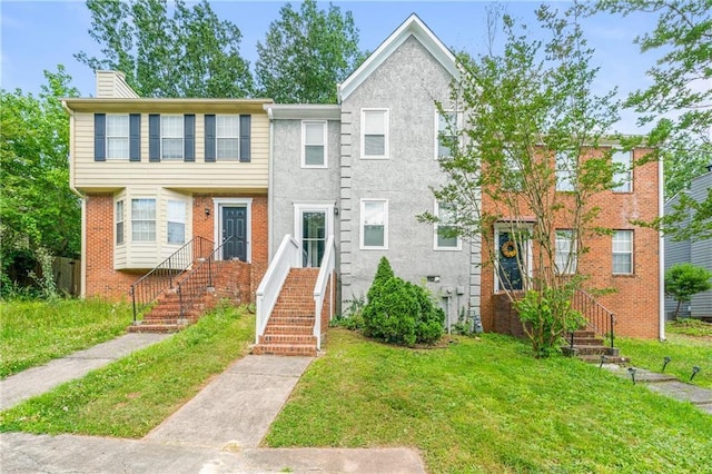 townhome / multi-family property with a front lawn