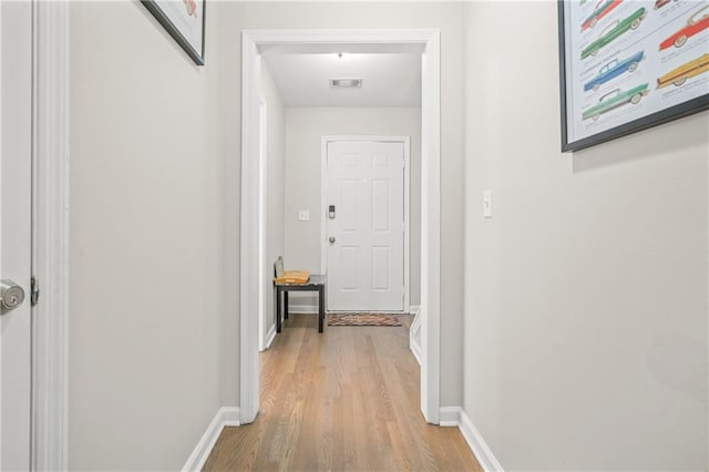 hall with light hardwood / wood-style floors