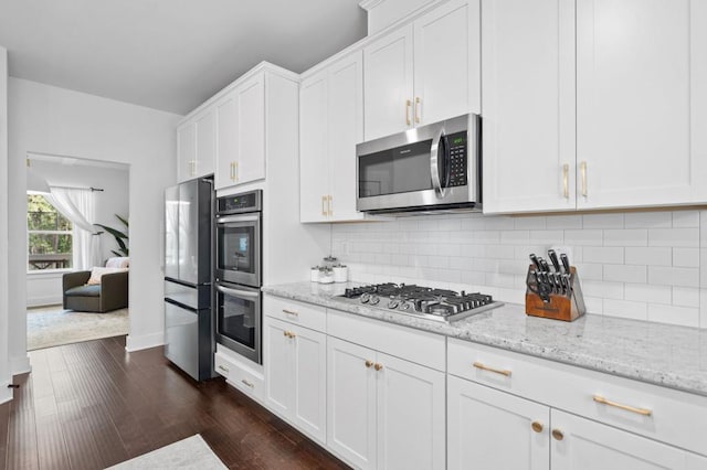 178 Crestbrook Way, Dallas, GA 30157 - kitchen with stainless steel appliances, dark wood-style flooring, white cabinets, light stone counters, and decorative backsplash