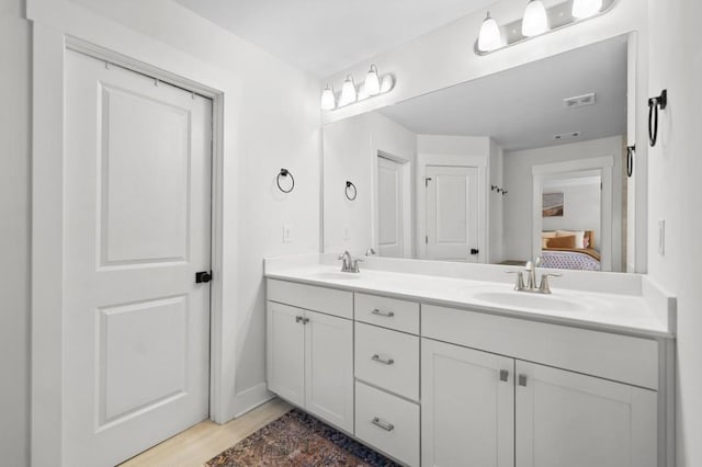 178 Crestbrook Way, Dallas, GA 30157 - ensuite bathroom featuring double vanity, wood finished floors, and baseboards