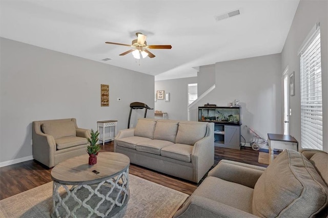 living room featuring ceiling fan and dark hardwood / wood-style flooring