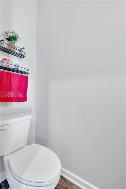 bathroom with hardwood / wood-style floors and toilet