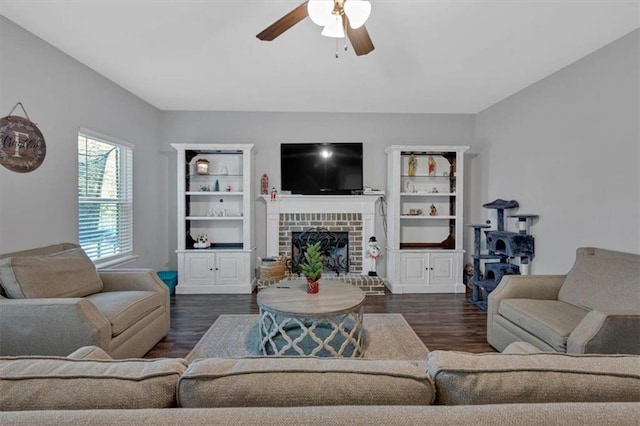 living room featuring a fireplace, ceiling fan, and dark hardwood / wood-style flooring