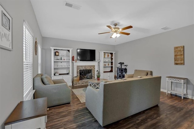 living room with ceiling fan, dark hardwood / wood-style flooring, and a fireplace