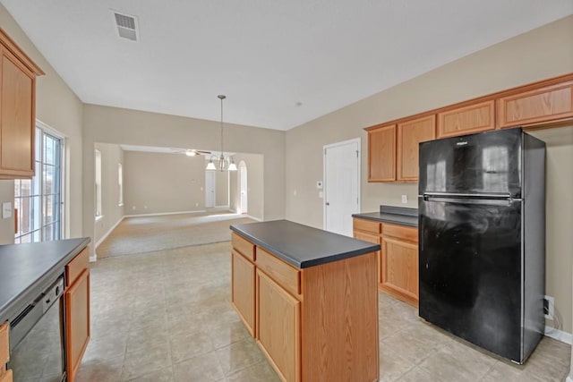 kitchen with pendant lighting, dishwasher, a center island, light tile patterned floors, and black fridge