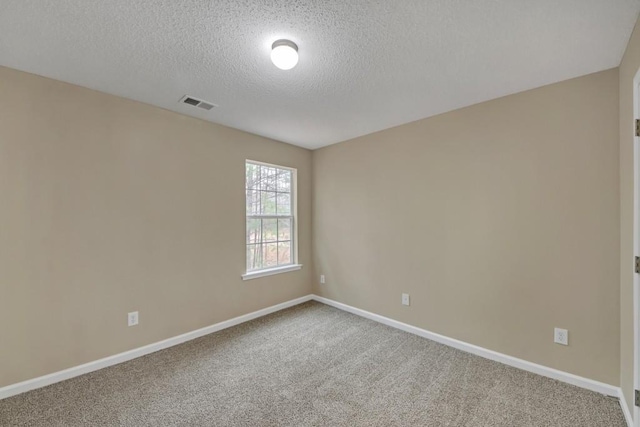 spare room with carpet floors and a textured ceiling