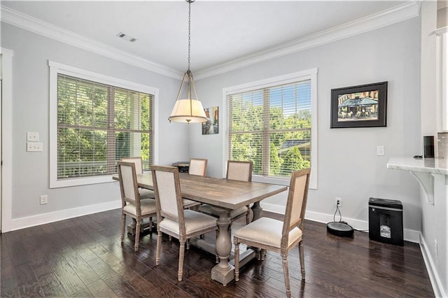 dining area with crown molding and dark hardwood / wood-style floors