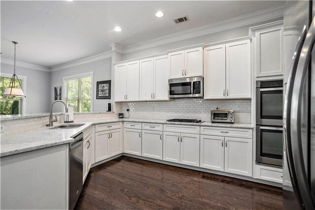 kitchen with white cabinetry, appliances with stainless steel finishes, and dark wood-type flooring