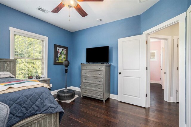 bedroom with ceiling fan and dark hardwood / wood-style flooring