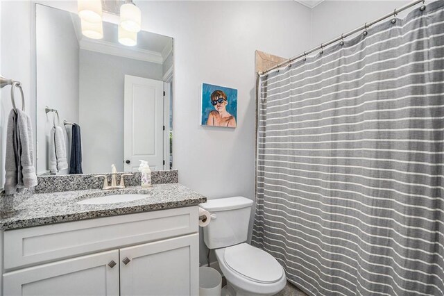 bathroom featuring ornamental molding, vanity, and toilet