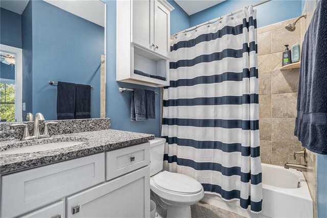 full bathroom with shower / tub combo, vanity, and toilet