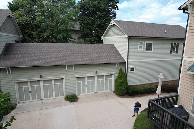 back of property featuring a garage