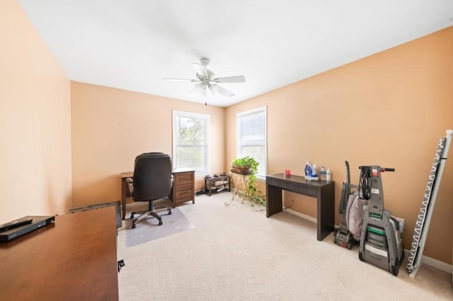 office space with ceiling fan, carpet floors, and baseboards