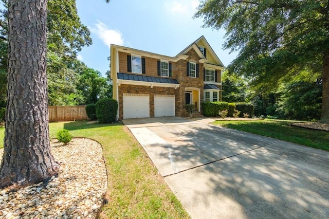 view of front facade with an attached garage, a standing seam roof, fence, driveway, and a front lawn